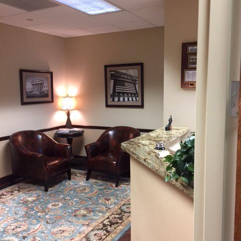 The reception waiting area at Herman Law with comfortable brown leather seats