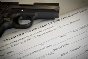 Firearm laying next to a firearm carry license in West Palm Beach.